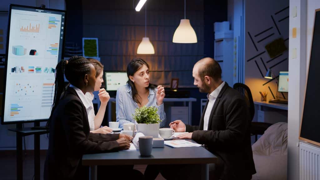 executive manager woman explaining management statistics working company strategy overtime office meeting room