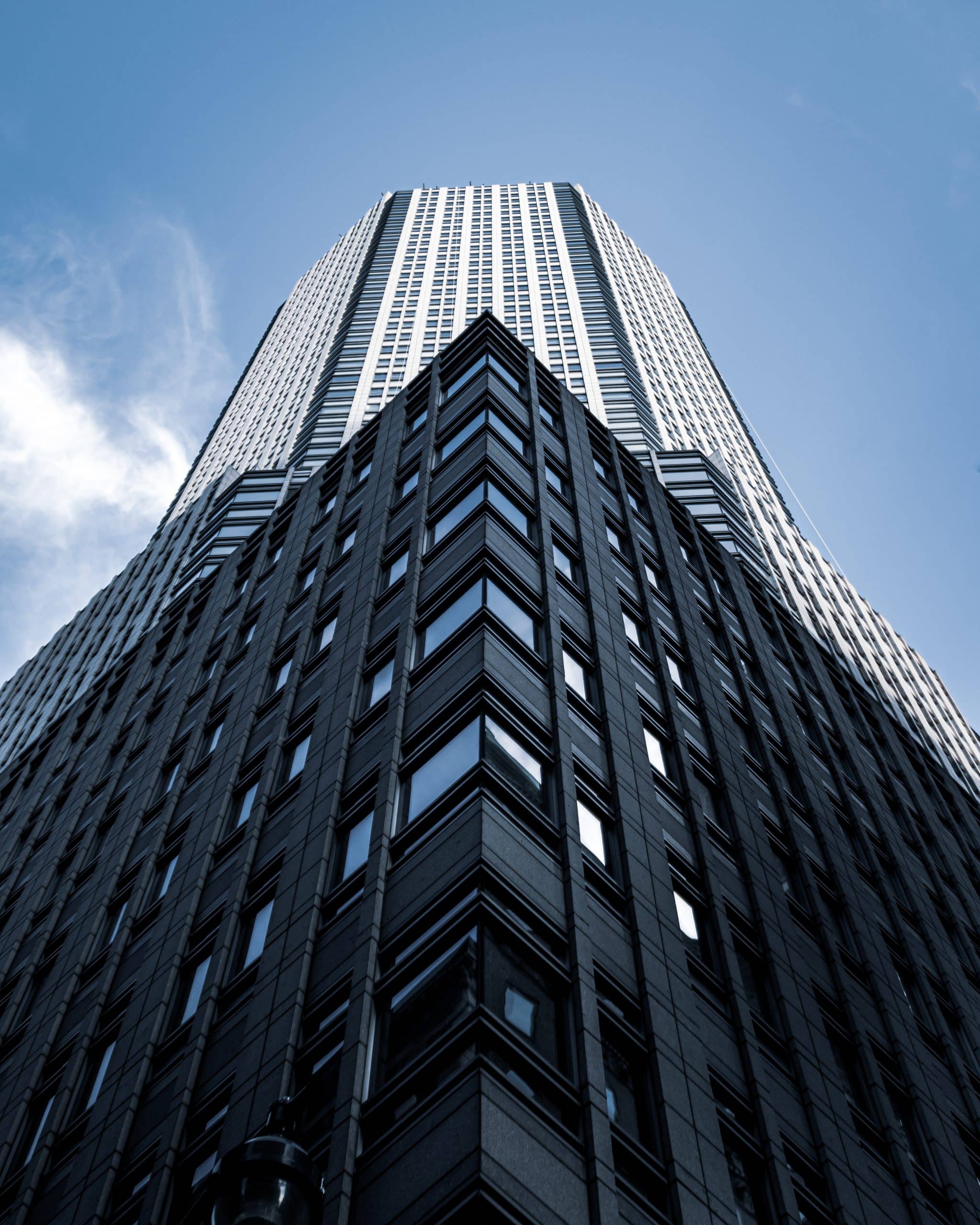 low angle shot tall city building with blue sky background new york scaled