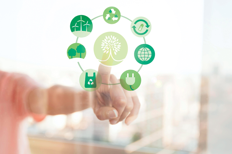 The image features a person pointing at an interactive graphic that represents various eco-friendly and sustainable concepts. The graphic includes icons for renewable energy (wind turbines), recycling, waste reduction, tree conservation, eco-friendly bags, clean energy, and the global environment, all encircling a central symbol of a tree. The background is blurred, emphasizing the eco-themed symbols as part of the Mergers and Acquisition Trends in 2025