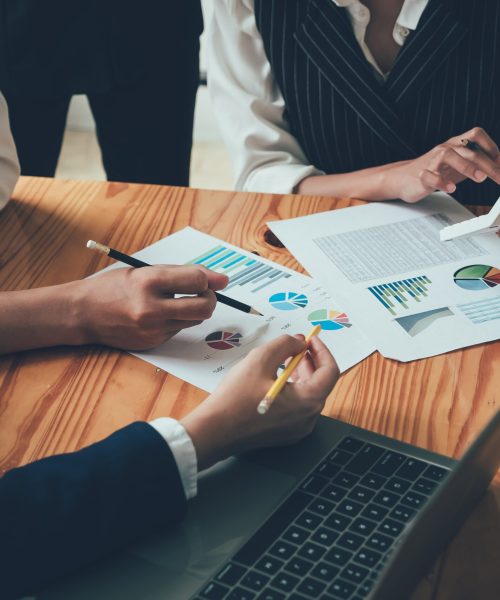 financial advisory services. Group of business advisor showing plan of investment to clients in the consultancy office.